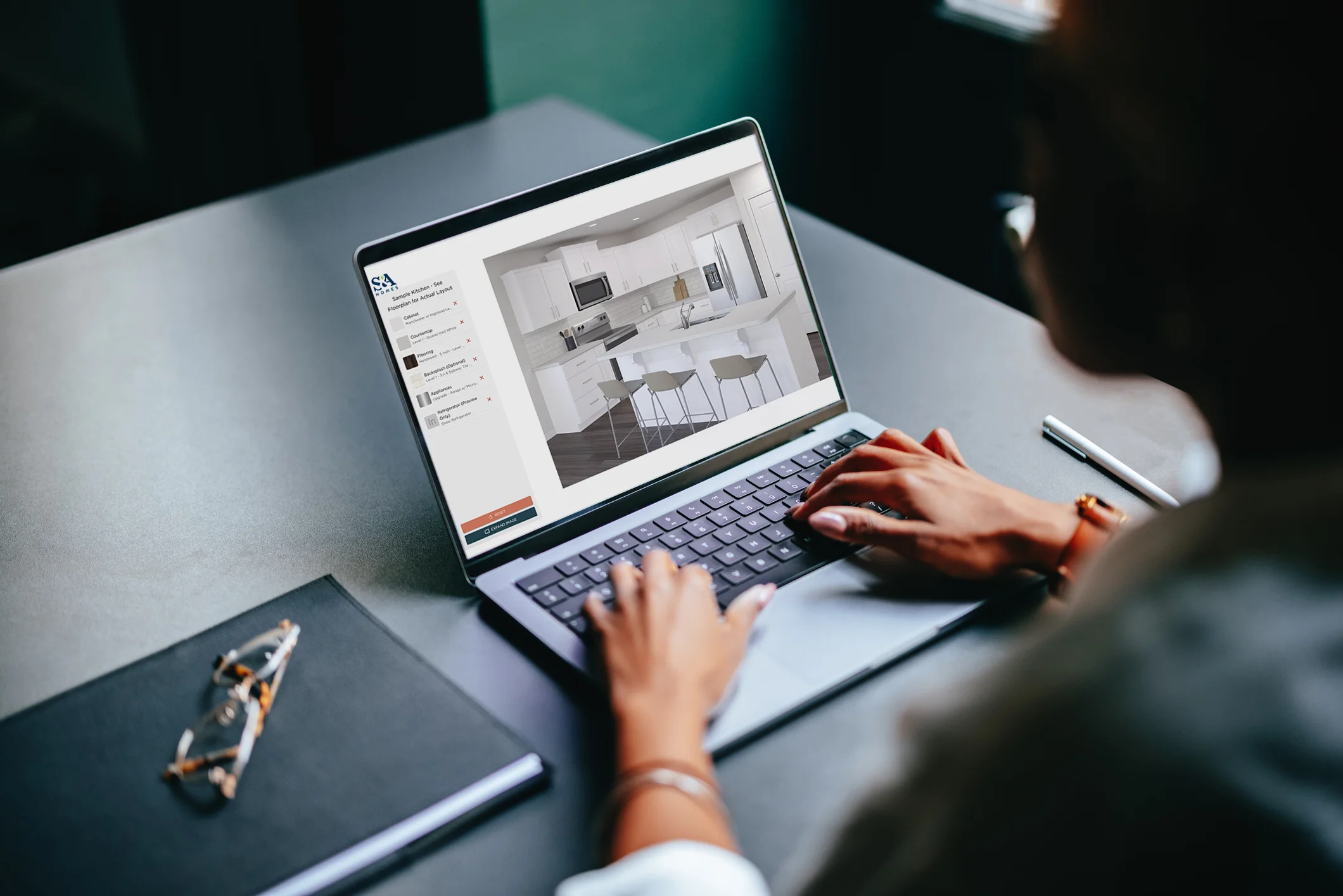 User on a laptop using S&A Kitchen Visualizer tool