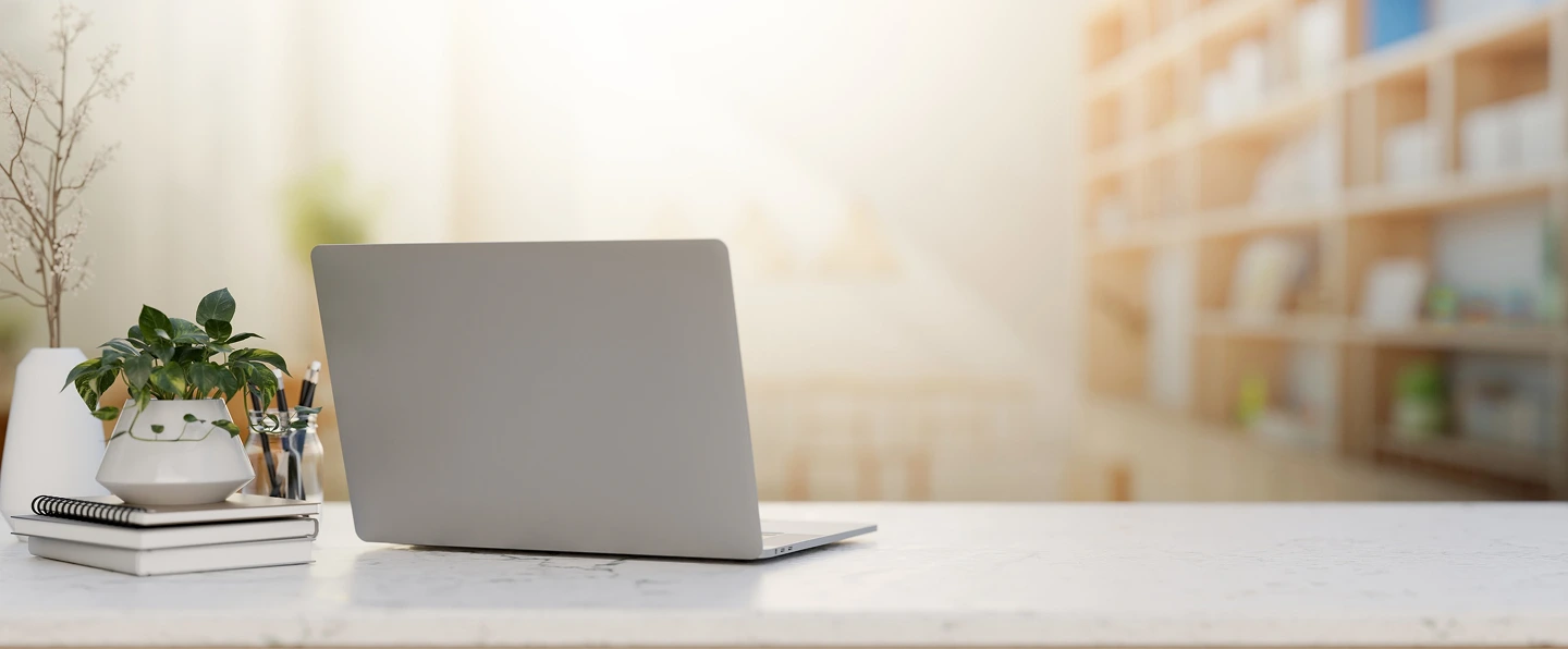 Laptop placed on a desk in a naturally-lit room